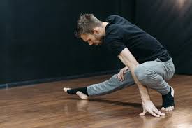 a man bending over on a wood floor