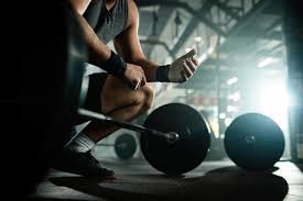 a man lifting weights in a gym